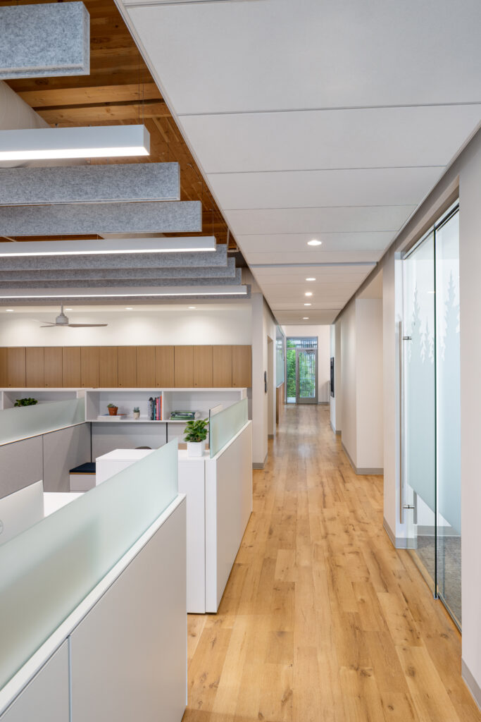 Open-plan office corridor with frosted glass partitions, wooden floor, and ceiling panels under soft lighting at the far endcozy workspace vibes](https://)